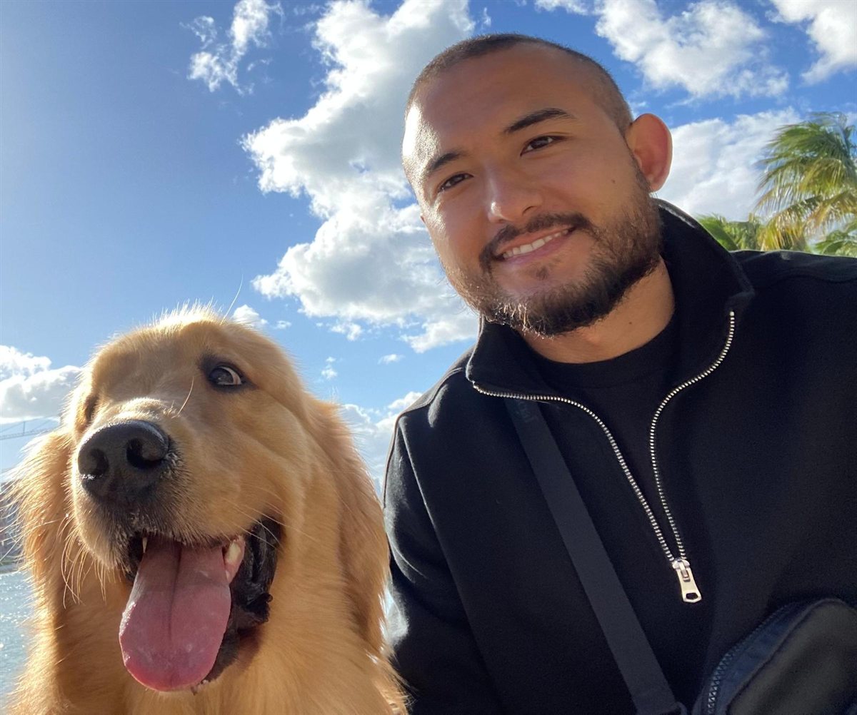 Franco Celeste, founder of Logic Talk AI, with his golden retriever on Miami's waterfront